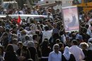 Supporters of Egypt's former intelligence chief Suleiman carry a poster of him during funeral procession in Heliopolis