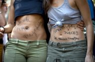 Women with slogans written on their bodies reading "Yes to life, but I choose" and "Priests and judges out of my body" take part in a protest against a reform of the country's abortion law recently proposed by the Spanish conservative government, at Tirso de Molina Square in Madrid. (AFP Photo/Dani Pozo)
