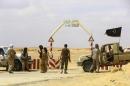 Rebels under Libyan rebel leader Jathran guard the entrance of the al-Ghani oil field, south of Ras Lanuf