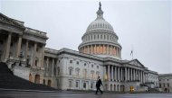 A man walks past the U.S. Capitol Building in Washington December 17, 2012. REUTERS/Joshua Roberts
