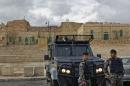 Jordanian security forces and their armored vehicles stand guard in front of Karak Castle in the central town of Karak, about 140 kilometers (87 miles) south of the capital Amman, in Jordan on Monday, Dec. 19, 2016. Gunmen assaulted Jordanian police in a series of attacks Sunday, including at the Karak Crusader castle popular with tourists, officials said. (AP Photo/Ben Curtis)