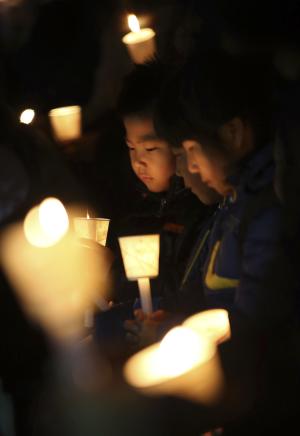 Kindergartens hold candles as they pray for safe return &hellip;