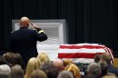 FILE - In this Saturday, March 3, 2012 file photo, Maj. Gen. David Quantock salutes Army Sgt. Timothy John Conrad, 22, who was killed in Afghanistan last week, at Conrad's funeral at Northside High School's auditorium in Roanoke, Va.. The 22-year-old Conrad was one of two U.S. military police officers killed Feb. 23 by an Afghan soldier amid anti-American sentiment over the burning of Qurans at a U.S. military base. The Afghan government is blaming the onslaught of attacks by Afghan police and soldiers against international forces on "infiltration by foreign spy agencies." Presidential spokesman Aimal Faizi told reporters Wednesday, Aug. 22, 2012 that intelligence services, including those in neighboring countries, are playing a part in most insider attacks.(AP Photo/The Roanoke Times, Rebecca Barnett, File)
