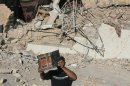 An Iraqis man retrieves a copy of the Koran from the debris of the Al-Hussein mosque following an explosion in the district of al-Musayyib on September 30, 2013