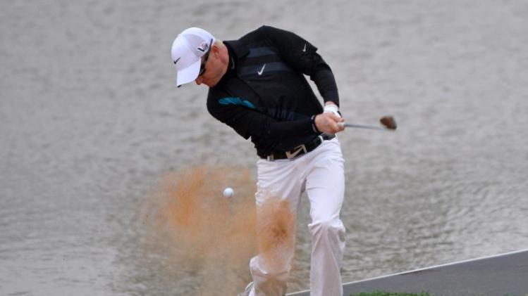 Simon Dyson plays a bunker shot at the 18th hole before finishing equal second at 4 under par on day two of the BMW Shanghai Masters at the Lake Malaren Golf Club in Shanghai on October 25, 2013