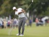 Woods hits his approach shot into the 18th green during third round play in the 2013 WGC-Cadillac Championship PGA golf tournament in Doral