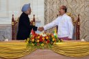 Indian PM Manmohan Singh (left) shakes hands with Myanmar President Thein Sein during their meeting in Naypyidaw