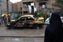 Iraqis gather at the site of a car bomb explosion in the Hurriyah neighbourhood of the capital Baghdad on February 3, 2014