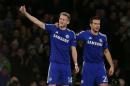 Chelsea's Andre Schurrle, left, celebrates scoring with teammate Cesar Azpilicueta during the Champions League Group G soccer match between Chelsea and Sporting Lisbon at Stamford Bridge in London, Wednesday, Dec. 10, 2014. (AP Photo/Tim Ireland)