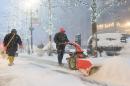 A man pushes a hand-driven snow plough in New York