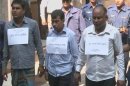 Still image taken from video footage shows three supervisors of a Bangladeshi garment factory being escorted by the police after their arrest in Dhaka