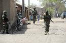 A photo taken on April 30, 2013 shows soldiers walking in the street in the remote northeast town of Baga, Borno State