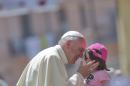 Pope Francis kisses a girl in front the Duomo of Cassano allo Jonio, southern Italy, Saturday, June 21, 2014. Pope Francis is paying a one day visit to Castrovillari, Sibari, and Cassano allo Jonio, in the Calabria region of Italy. (AP Photo/Alessandra Tarantino)