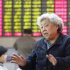 A woman chats with her fellow investor at a private securities company Tuesday, March 12, 2013 in Shanghai, China. Asian stock markets dropped Tuesday, dragged down by new worries about China's recovery and Europe's doldrums. (AP Photo)