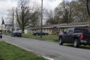 Police tape is seen around a house in Manchester, Ill., Wednesday, April 24, 2013, where the bodies of five people were found slain early Wednesday in the tiny southwestern Illinois town. Authorities said a suspect was injured and taken into custody. (AP Photo/Regina Garcia Cano)