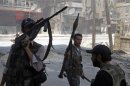 Free Syrian Army fighters hold their weapons during clashes in the Salaheddine neighbourhood of central Aleppo