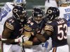 Chicago Bears linebacker Brian Urlacher (54) celebrates with Israel Idonije (71) and Nick Roach (53) after he recovered fumble against the Detroit Lions near the goal line in the second half of an NFL football game in Chicago, Monday, Oct. 22, 2012. (AP Photo/Kiichiro Sato)