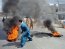A Pakistani demonstrator drags burning tyres during a protest against an anti-Islam film in Rawalpindi