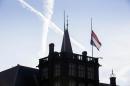 A flag flies half-staff at Binnenhof, the seat of the Dutch government, in The Hague, Netherlands, Friday, July 18, 2014. Flags are flying half-staff across the Netherlands as the country mourns at least 154 of its citizens killed when a Malaysia Airlines passenger jet was shot down in eastern Ukraine. (AP Photo/Phil Nijhuis)