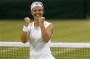 Kirsten Flipkens of Belgium celebrates after defeating Petra Kvitova of the Czech Republic in their women's quarter-final tennis match at the Wimbledon Tennis Championships, in London