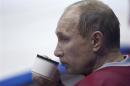 Russian President Putin drinks from a cup during a friendly ice hockey match in the Bolshoi Ice Palace near Sochi