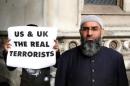 Demonstrator Anjem Choudary, protests in support of Islamist cleric Abu Hamza al-Masri, outside the High Court in London