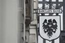 A logo hangs outside a branch of Barclays bank in London