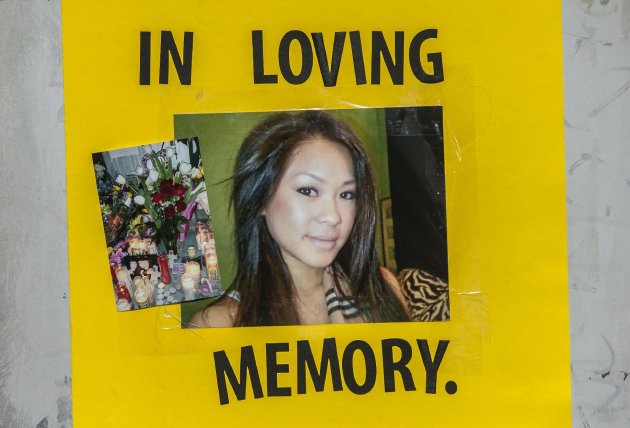 A picture of Kim Pham is among the items placed at a make-shift memorial Friday, Jan. 24, 2014, for Pham, who was beaten to death in front of The Crosby nightclub in Santa Ana, Calif. Two women were arrested and a third "person of interest" is being sought by police. (AP Photo/The Orange County Register, Bruce Chambers) MAGS OUT; LOS ANGELES TIMES OUT