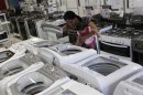A woman and her daughter look at a washing machine at a Casas Bahia store in Sao Paulo