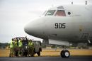 Ground staff assist a ROKN P-3C Orion maritime patrol aircraft after it arrived at the RAAF Base Pearce, before searching for missing Malaysia Airlines flight MH370