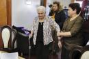 America Maria Hernandez, 99, left, is aided by her granddaughter Monica Martinez, center, and daughter Ana Martinez as she prepares to take the Naturalization Oath of Allegiance, Wednesday, Nov. 23, 2016, in the Queens borough of New York. The Colombian immigrant, who was brought to the U.S. by one of her daughters in 1988, signed her naturalization certificate and took the oath of allegiance in her living room, surrounded by family members and TV cameras. (AP Photo/Richard Drew)