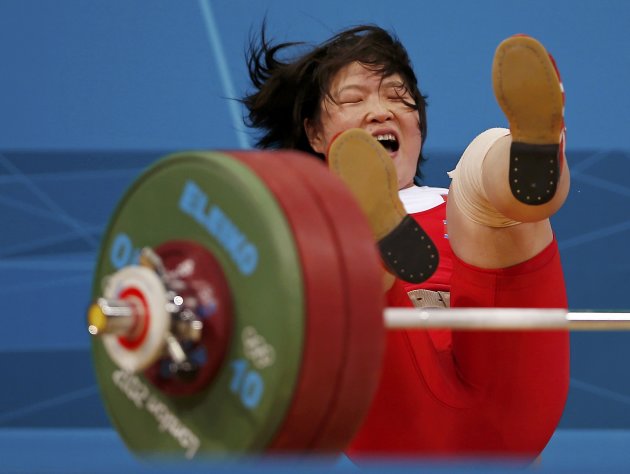 North Korea's Jong Sim Rim falls after failed attempt on the women's 69Kg Group A weightlifting competition at the ExCel venue at the  London 2012 Olympic Games