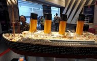 This file photo shows a visitor looking at the model of the original Titanic, displayed at an exhibition in Bangkok, in June. Titanic, which was built in Belfast, sank on its first voyage from Southampton to New York, killing more than 1,500 passengers and crew