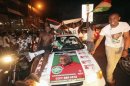 Supporters of the NDC party celebrate the victory of their candidate John Dramani Mahama, along a street in Accra