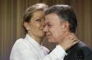 Colombia's President Juan Manuel Santos is embraced by his wife Maria Clemencia Rodriguez after speaking to journalists at the presidential palace in Bogota, Colombia, Friday, Oct. 7, 2016. Santos won the Nobel Peace Prize Friday, just days after voters narrowly rejected a peace deal he signed with rebels of the Revolutionary Armed Forces of Colombia, FARC. (AP Photo/Fernando Vergara)