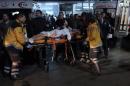 Rescue and medics carry a wounded person after attacks in Istanbul, late Saturday, Dec. 10, 2016. Two explosions struck Saturday night outside a major soccer stadium in Istanbul after fans had gone home, an attack that wounded about 20 police officers, Turkish authorities said. One of the blasts was thought to be a car bomb. Turkish authorities have banned distribution of images relating to the Istanbul explosions within Turkey.(AP Photo/Cansu Alkaya)