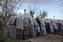 Macedonian policemen shelter behind their shields from stones hurled by migrants during clashes at the Greek-Macedonian border, near the northern Greek village of Idomeni, Saturday, Nov. 28, 2015. Tension has flared on the Greek side of the Greece-Macedonia border when a migrant who was stopped from crossing into Macedonia, suffered severe burns when he climbed on top of a stationary train carriage and touched a overhead power cable. (AP Photo/Muhammed Muheisen)
