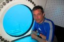 The grandson of famed French oceanographer Cousteau sits in the Aquarius undersea marine habitat and lab located in the Florida Keys National Marine Sanctuary near Key Largo