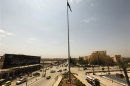 File photo shows the flag of the Islamist Syrian rebel group Jabhat al-Nusra flying over the main square of the city of Raqqa