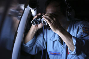 Vietnamese Air Force Col. Pham Minh Tuan uses binoculars&nbsp;&hellip;