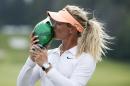 Suzann Pettersen, of Norway, kisses the winner's trophy at the 2015 Manulife LPGA Classic in Cambridge, Ontario, on Sunday, June 7, 2015. Pettersen finished with a score of -22, one shot better than American Brittany Lang who hit seven under to finish at -21 for the tournament. (Peter Power/The Canadian Press via AP) MANDATORY CREDIT