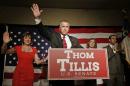 Thom Tillis waves to supporters as he celebrates