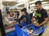 Erica Avegalio, center, and her brother Albert Avegalio, right, load up on water and food at the Times Supermarket after learning of a tsunami warning Saturday, Oct. 27, 2012, in Honolulu.  A tsunami warning has been issued for Hawaii after a 7.7-magnitude earthquake rocked an island off the west coast of Canada. The Pacific Tsunami Warning Center originally said there was no threat to the islands, but a warning was issued later Saturday and remains in effect until 7 p.m. Sunday. A small craft advisory is in effect until Sunday morning. (AP Photo/Eugene Tanner)