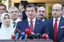 Turkish Prime Minister Ahmet Davutoglu (C) gives a press conference on October 10, 2014 in Ankara