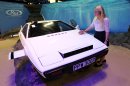 RM Auctions assistant Hannah Fairclough with the white Lotus Esprit used in the James Bond movie 