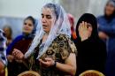 In this Saturday, July 19, 2014 photo, displaced Christians who fled the violence in Mosul, pray at Mar Aframa church in the town of Qaraqoush on the outskirts of Mosul. Iraq was home to an estimated 1 million Christians before the 2003 U.S.-led invasion that ousted Saddam Hussein. Since then, militants have frequently targeted Christians across the country, bombing their churches and killing clergymen. Under such pressures, many Christians have left the country. Church officials now put the community at around 450,000. (AP Photo)