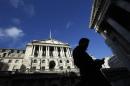 A man passes the Bank of England in the City of London