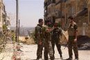 Syrian army troops loyal to Syria's president Bashar Al-Assad are seen in the areas of Sayf Al-dawla and al-Zibdeh