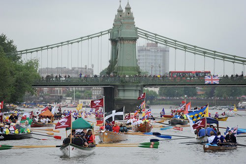 Rowing boats begin to gather on the River Thames during the Diamond Jubilee river pageant