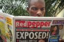 A Ugandan reads a copy of the "Red Pepper" tabloid newspaper in Kampala, Uganda Tuesday, Feb. 25, 2014. The Ugandan newspaper published a list Tuesday of what it called the country's "200 top" homosexuals, outing some Ugandans who previously had not identified themselves as gay, one day after the president Yoweri Museveni enacted a harsh anti-gay law. (AP Photo/Stephen Wandera)